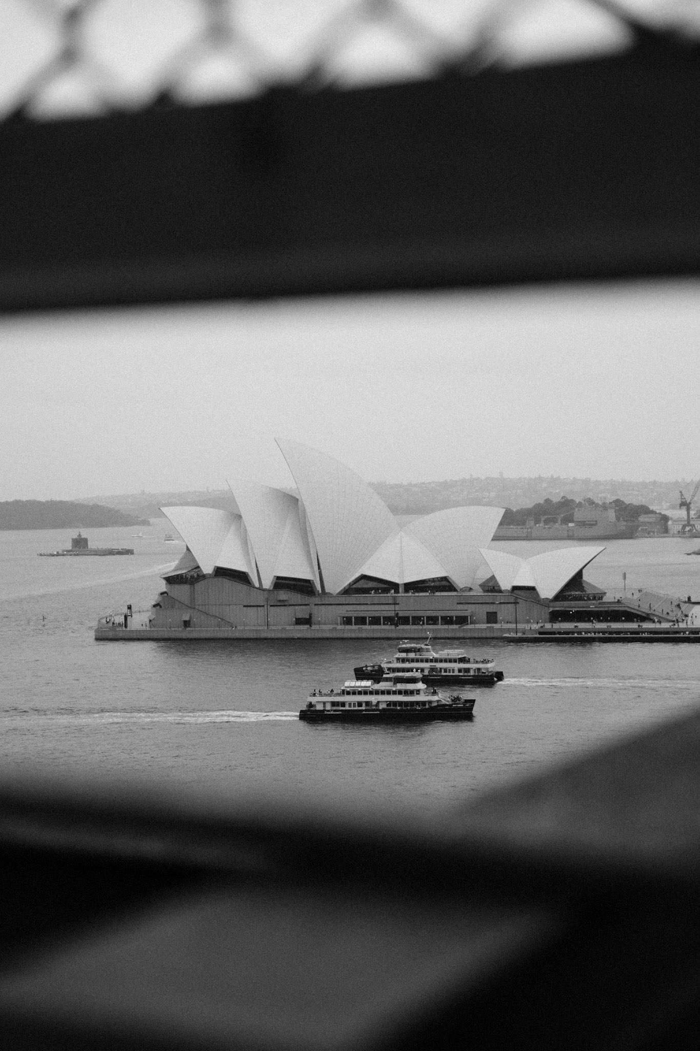 The Sydney Opera House and a ferry seen from the Harbour Bridge walkway