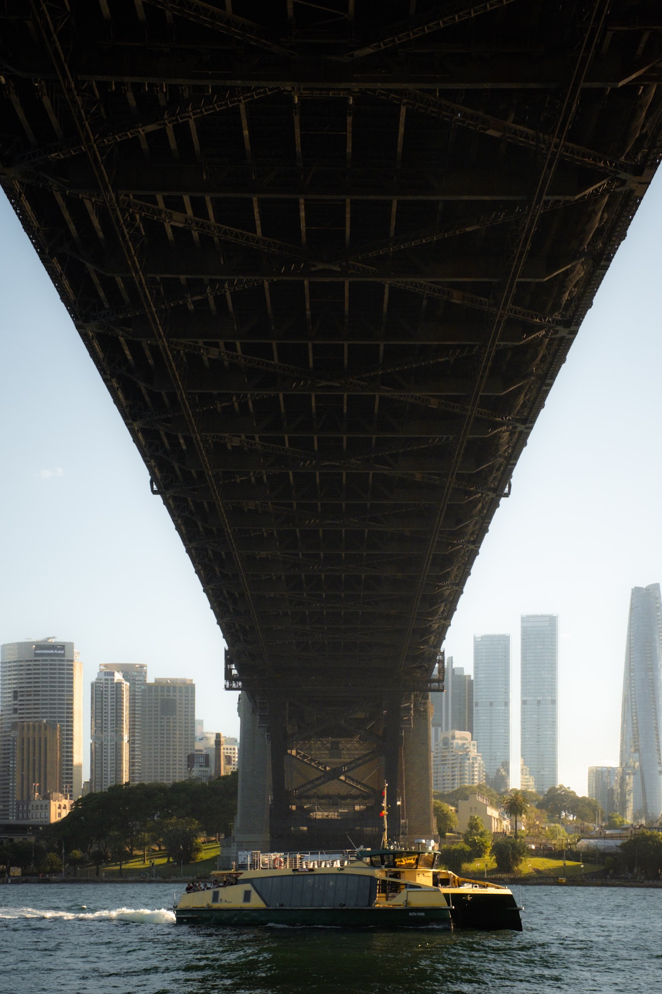 The city framed by the steelwork under the Harbour Bridge