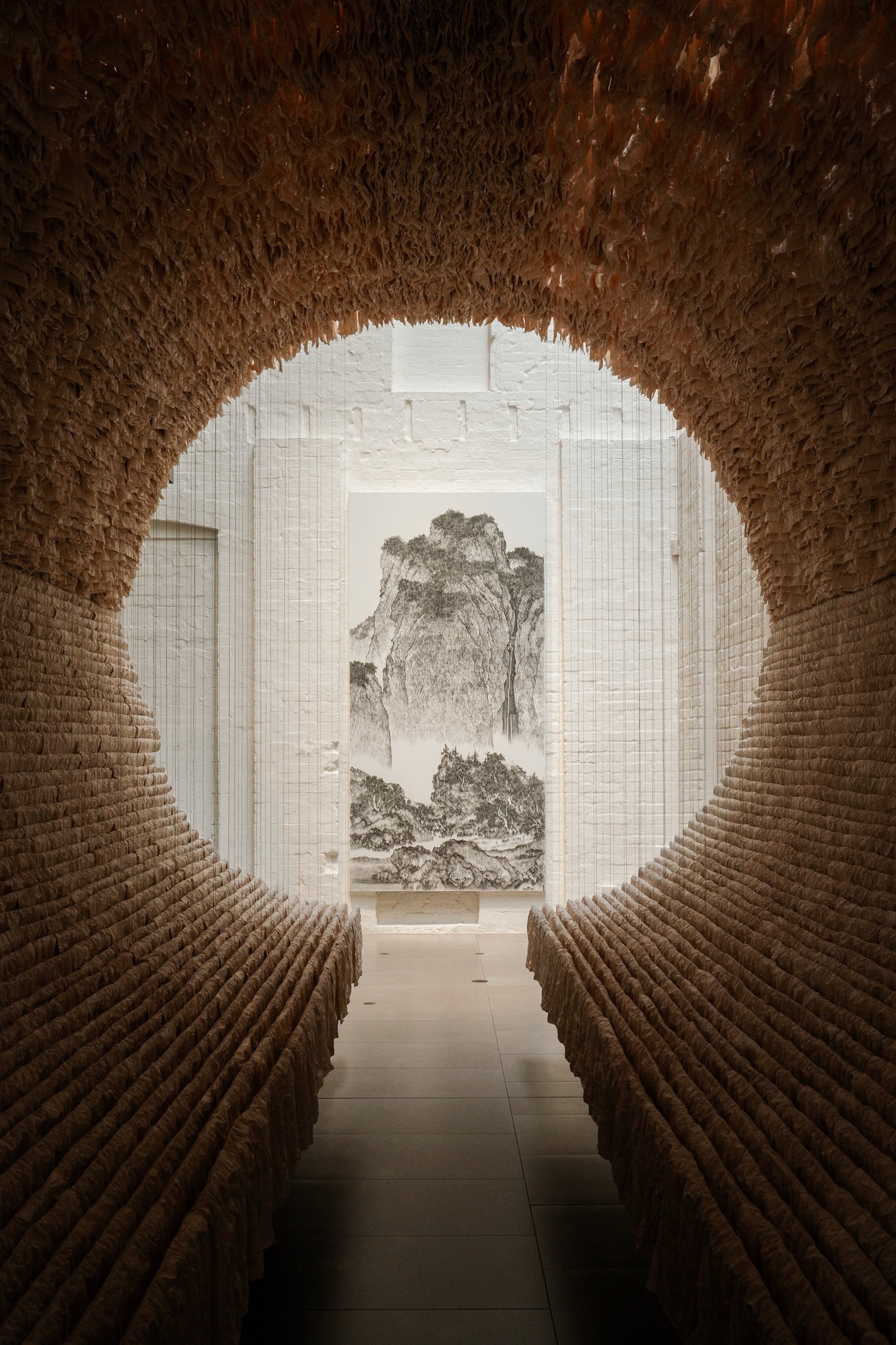 Looking through a circular opening to an ink landscape at White Rabbit Gallery