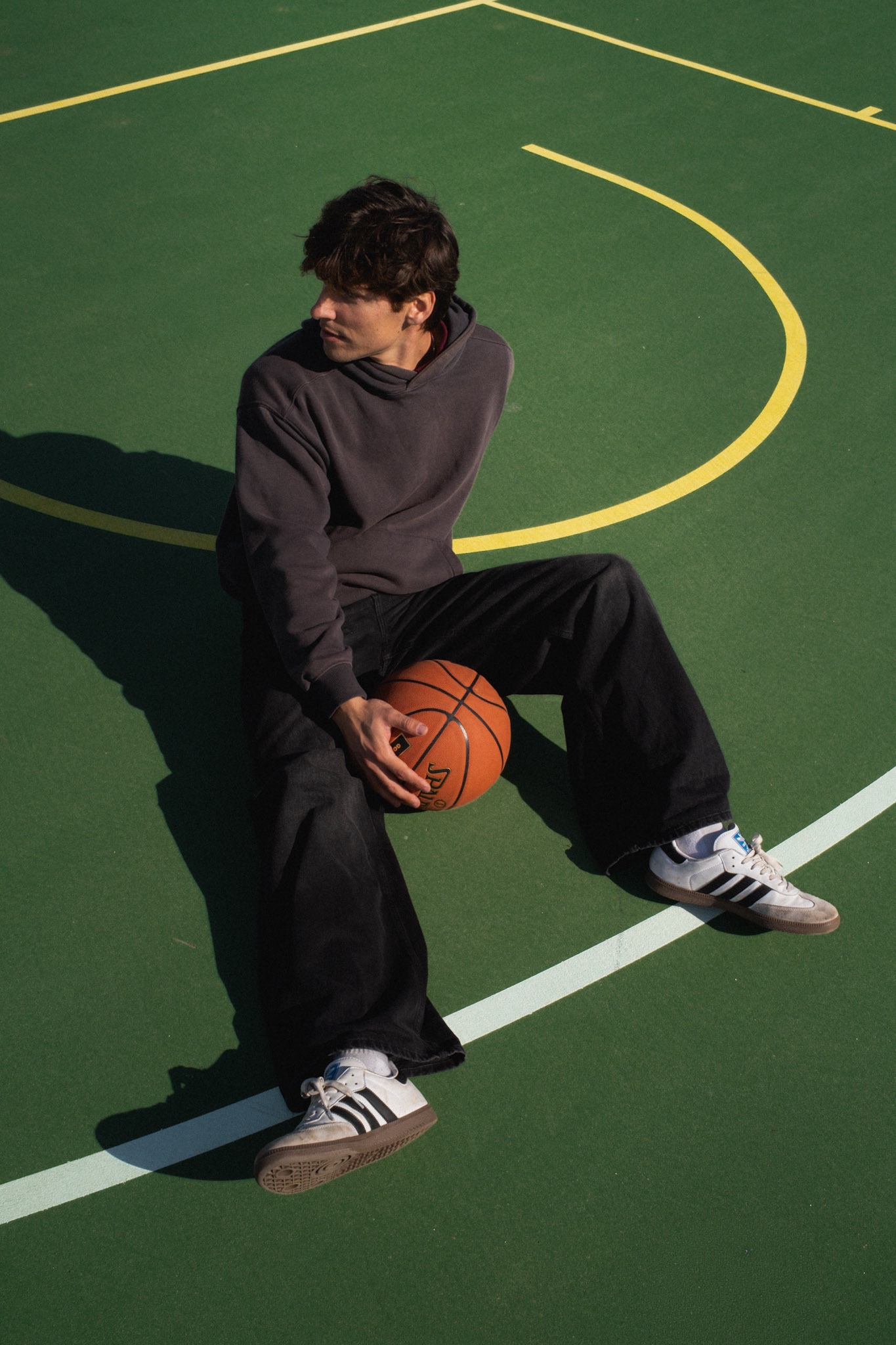 A lifestyle portrait on the green basketball court at Christison Park